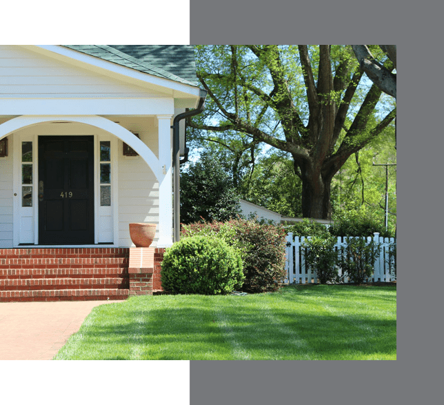 White house with a black front door labeled '419', a small white picket fence, and a large green tree on a sunny day, perfect for a real estate coach.